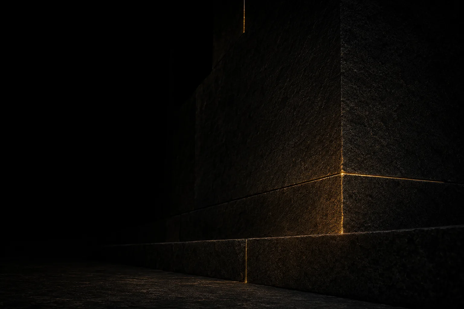 Massive dark granite blocks with a thin seam of molten gold running through the joints, the gold the only light source
