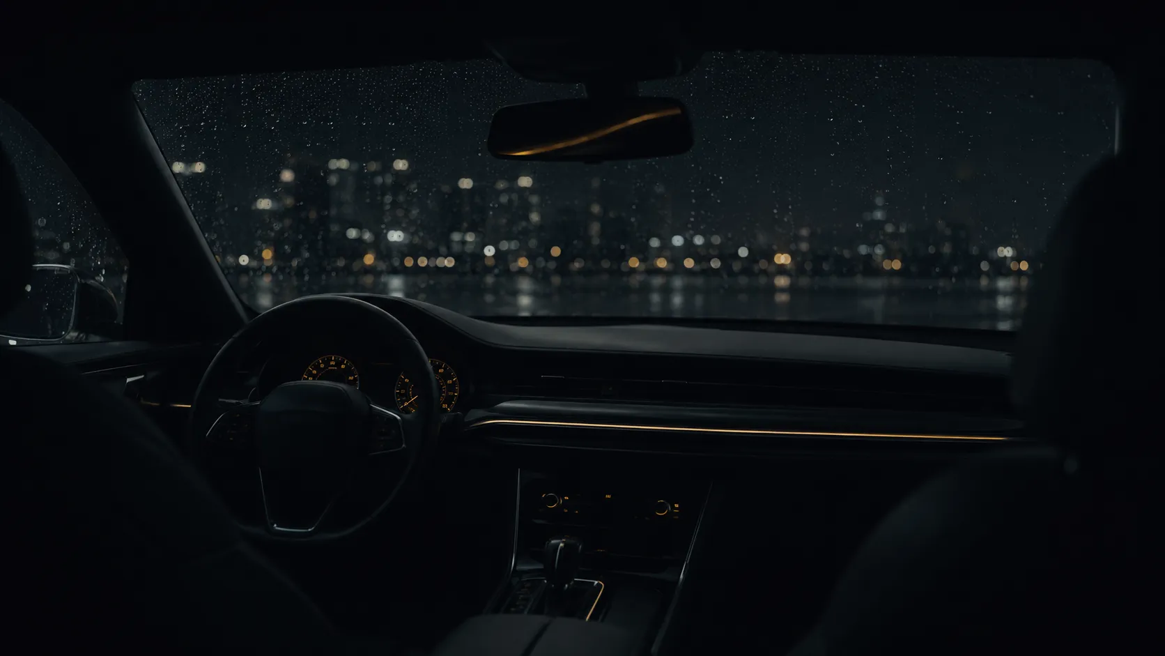 A parked car at night seen from the back seat, rain on the windshield refracting distant city lights